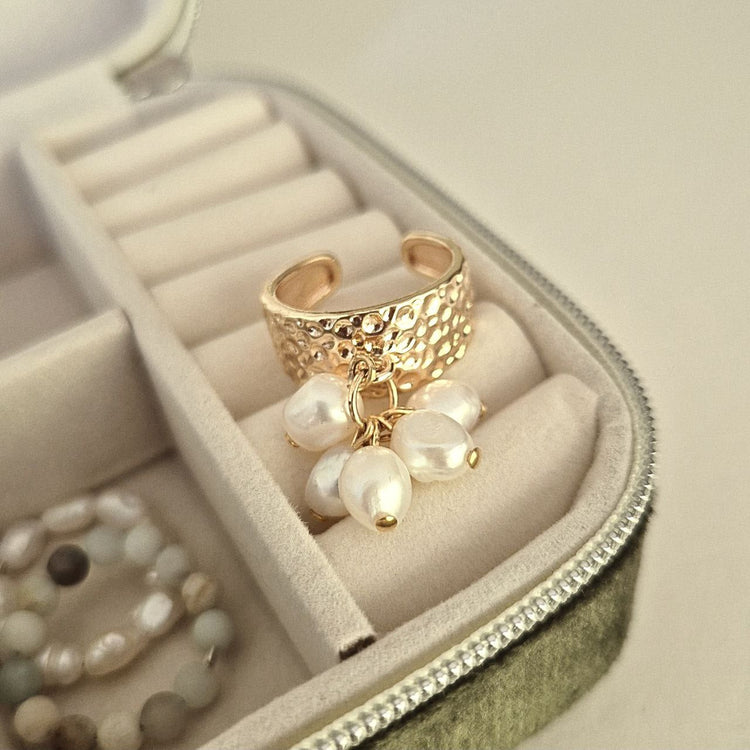 Gold ring with hammered texture and freshwater pearls in a velvet jewelry box
