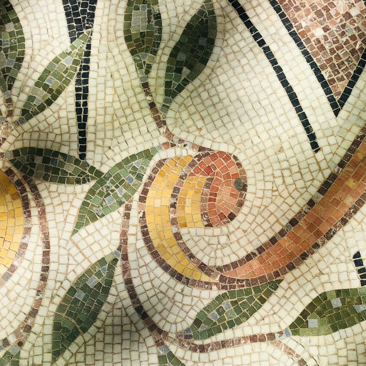 Mosaic design with fruit and leaves on a patterned background